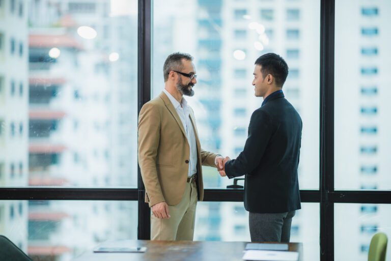 Two businessmen shake hands